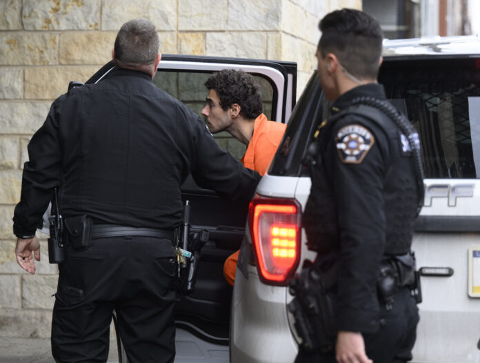 Suspected shooter Luigi Mangione is led into the Blair County Courthouse for an extradition hearing Dec. 10, 2024 in Hollidaysburg, Pennsylvania.